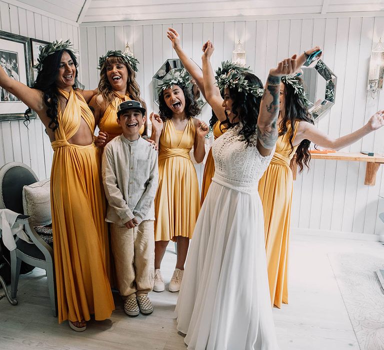 Bride celebrates with her bridesmaids who wear sunflower yellow bridesmaid dresses in different styles