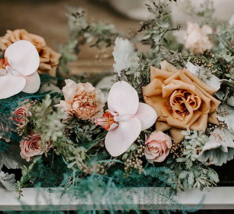 Romantic cafe au late roses, pink carnations, orchids and astilbe wedding flowers 