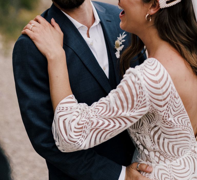 Bride wearing two pearl hair clips on the side of her hair 