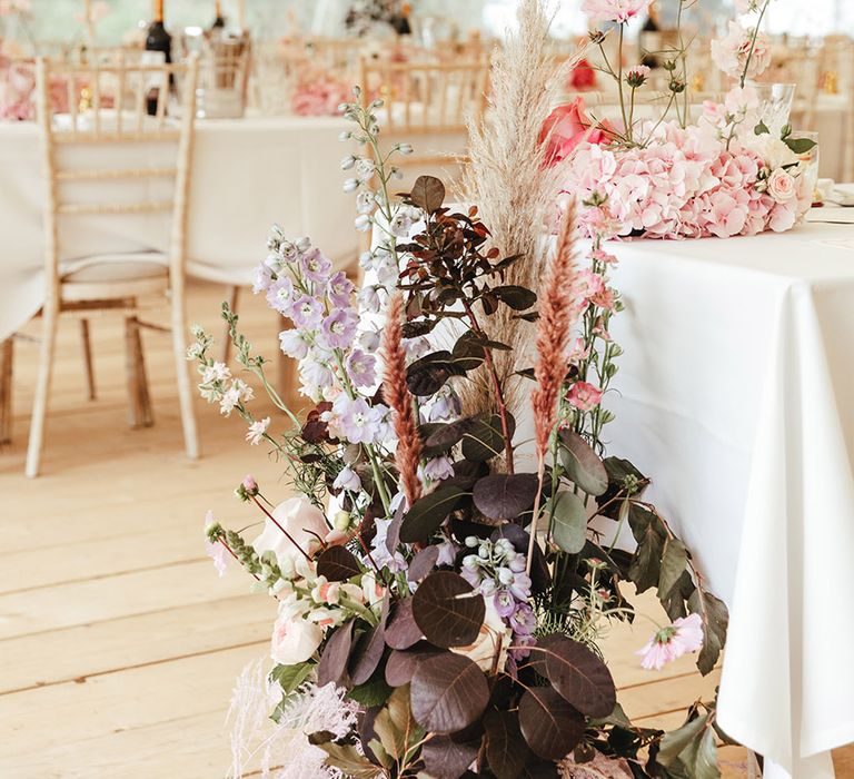 Marquee wedding with purple, pink and green wedding flower decorations