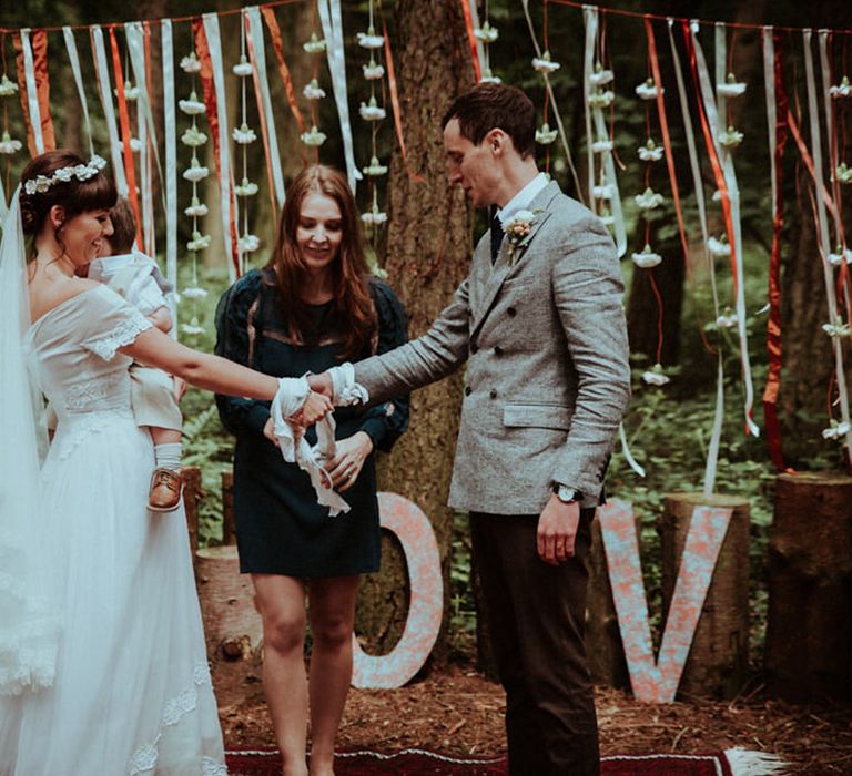 Woodland wedding with colourful ribbon wedding decor and handfasting ceremony