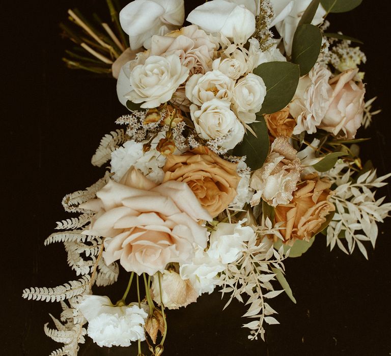 Neutral wedding bouquet with roses and foliage 