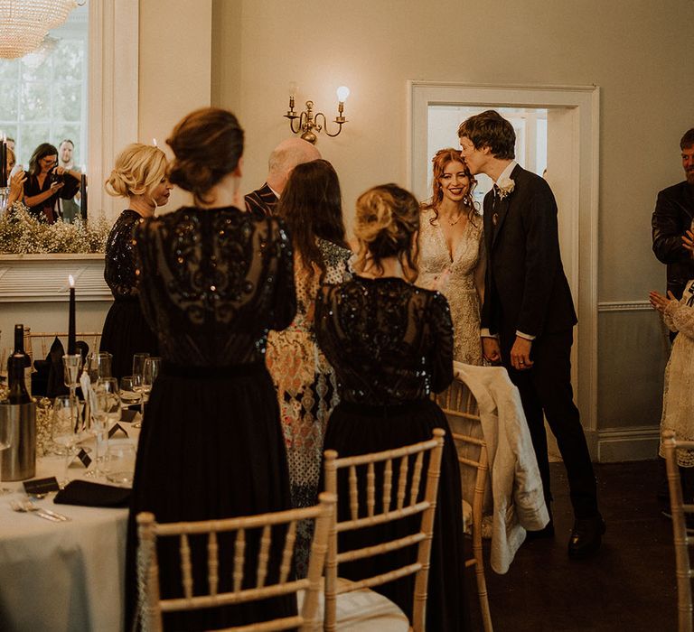 Bride & groom enter reception at Belair House as bridesmaids wearing sequin black bridesmaid dresses