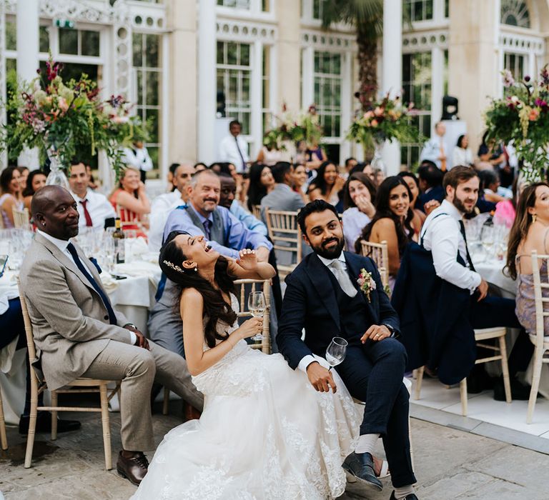 Bride & groom laugh during reception at Syon Park 