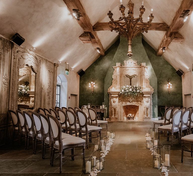 Le Petit Chateau aisle decor complete with white pillar candles lining the aisle and white petals 