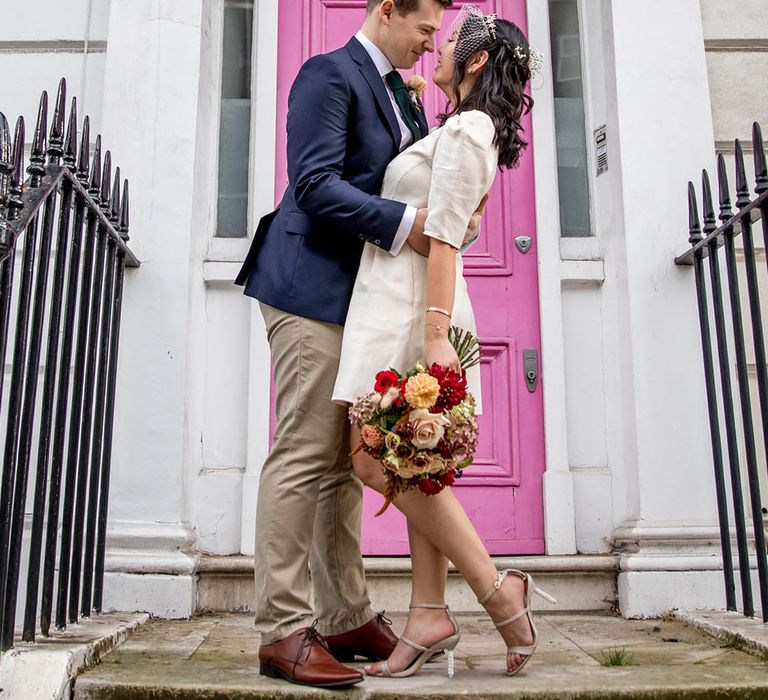 Bride wears short wedding dress complete with polka dot styled Juliet veil 