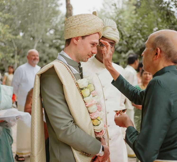 Groom in a green Sherwani at Domaine de Blanche Fleur Provence wedding