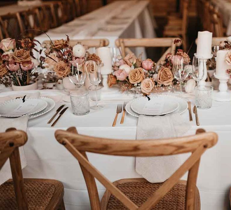 Rustic luxe wedding tablescape with toffee, nude and blush colour palette, soft linen table runners, gold cutlery and charger plates 