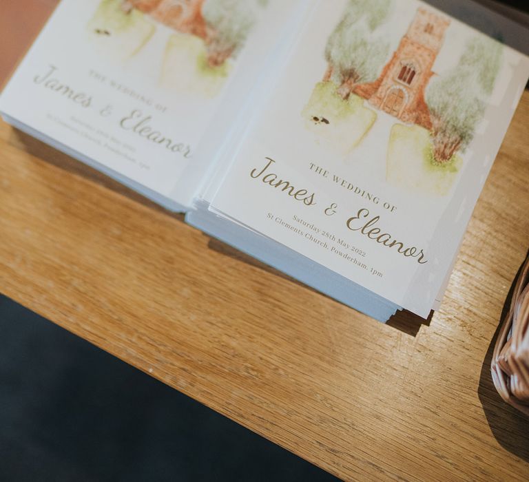 Order of service wedding booklets at the entrance to the church 