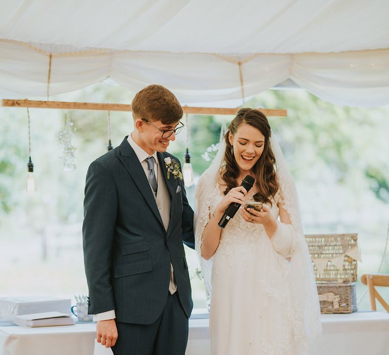 The bride and groom perform a joint wedding speech together for their wedding reception 