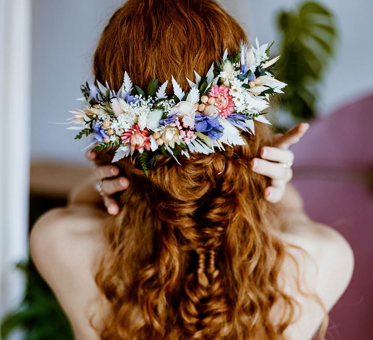 half up half down curly wedding hairstyle with dried flower hair accessory 