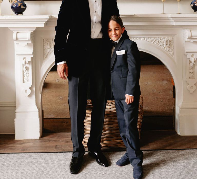 Groom in black tie with the page boy in black tie outfit 