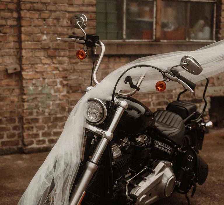 Wedding motorbike with church length wedding veil over the top of it 