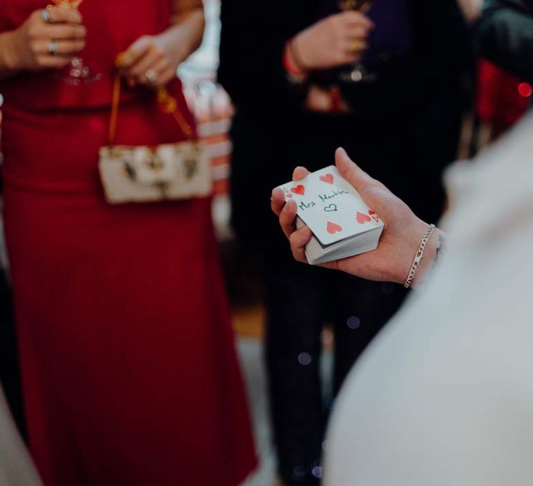 Live wedding magician playing a card trick with guests at Fabrica Brighton wedding 