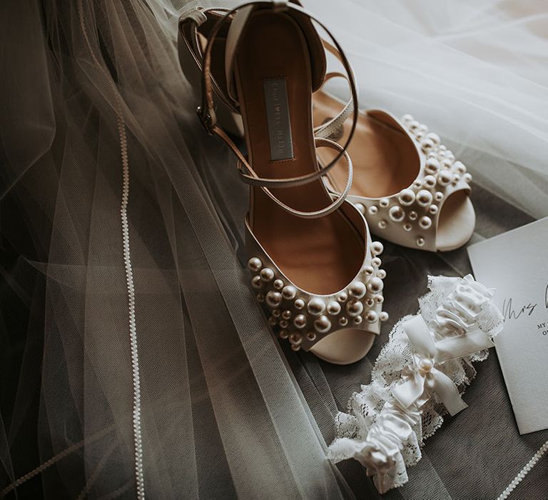 Charlotte Mills pearl wedding shoes with lace garter and personalised wedding stationery 