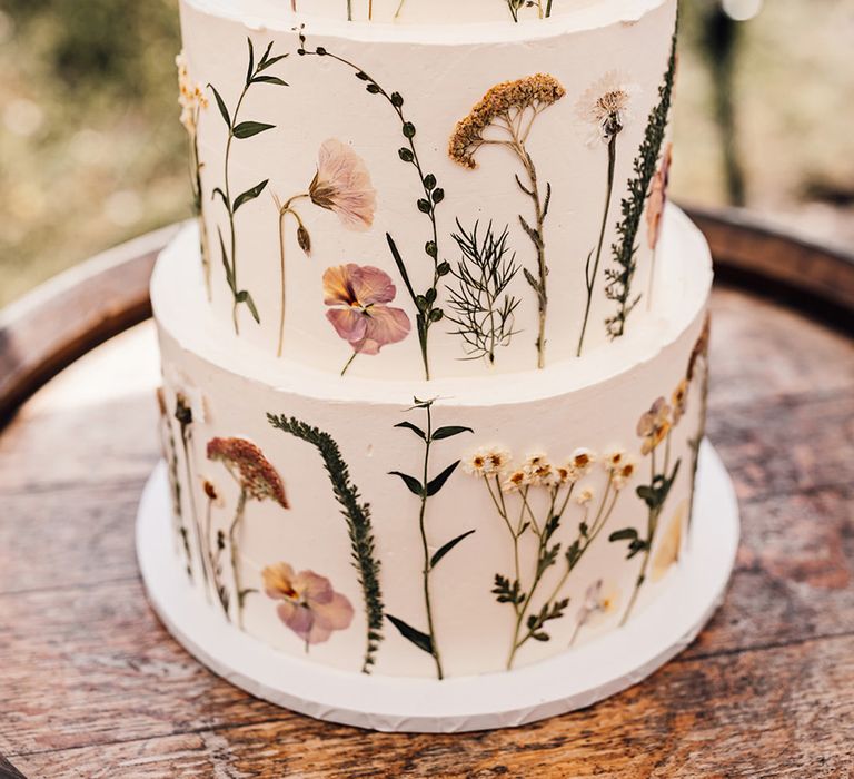 three-tier buttercream wedding cake with flower press design 