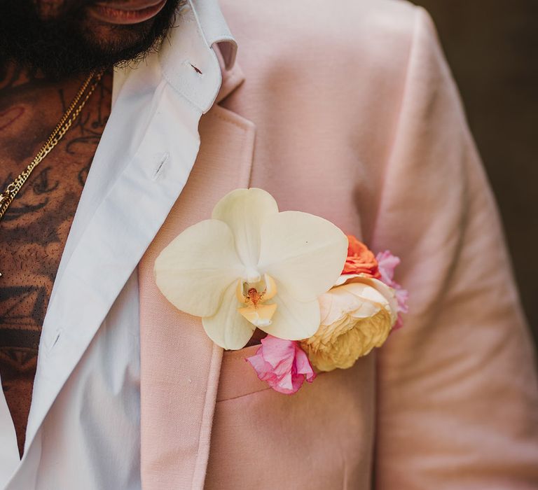 Pink wedding theme for Polstrong Manor wedding with groom in pink suit with orchid buttonhole 