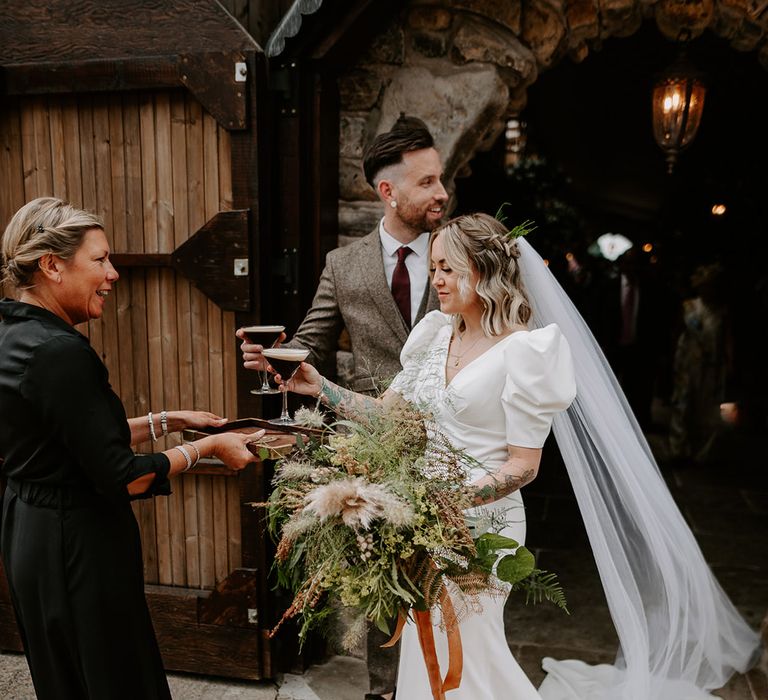 The bride and groom have their first official drink as a married couple as they pick up some espresso martinis 