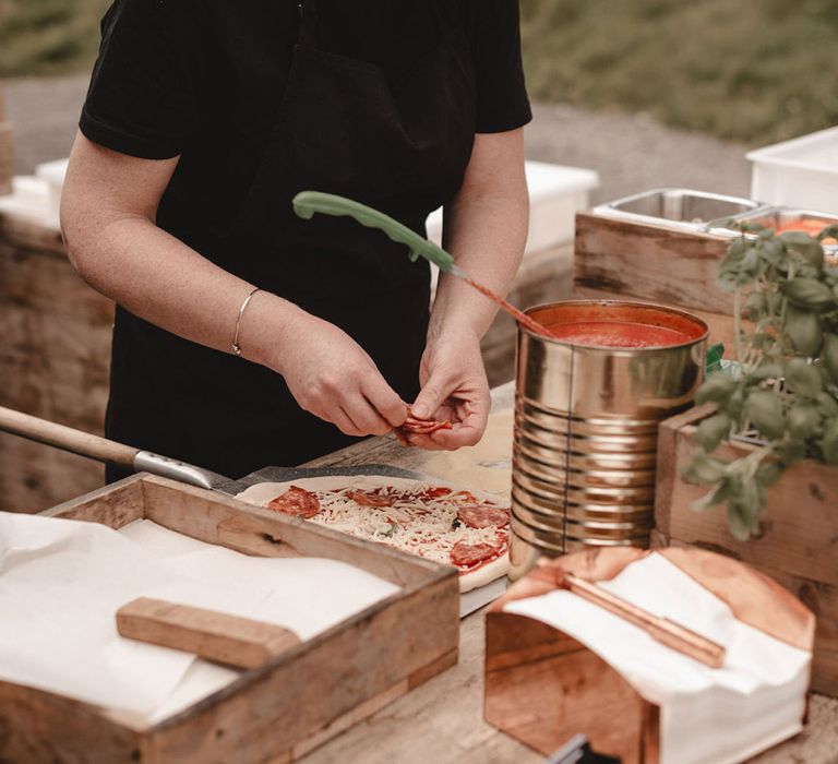 Wedding caterers making pizza for the wedding breakfast 