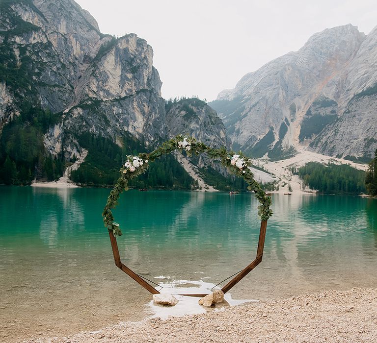 Lakeside wedding ceremony with floral moongate decoration 