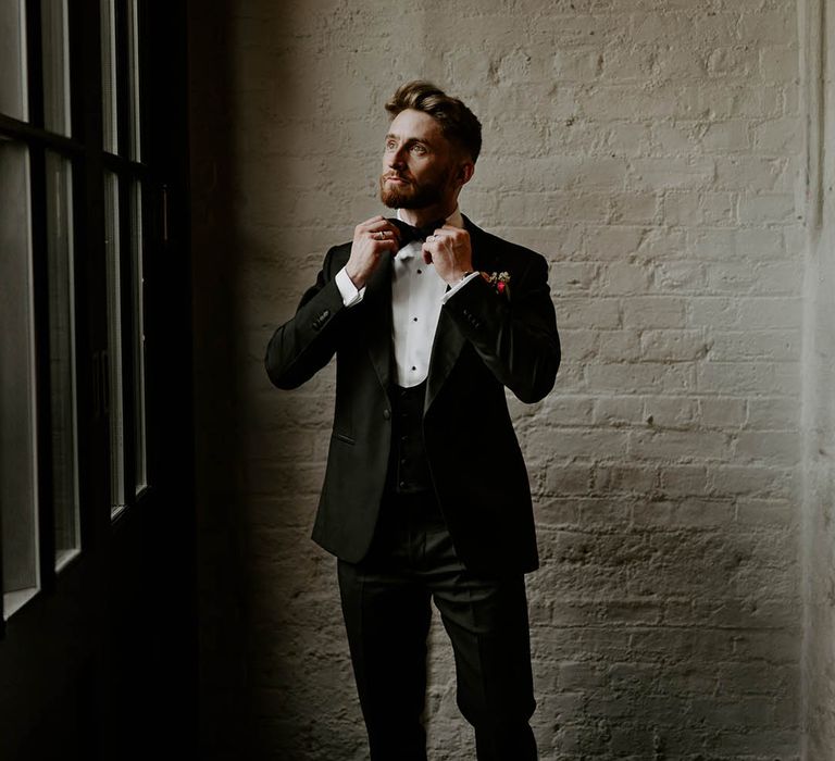 Groom in black tuxedo for traditional wedding fashion styling 