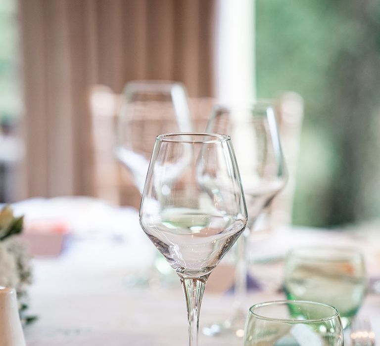 Wine glass with green coloured glassware on the classic wedding tablescape 