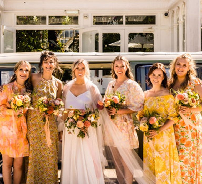 Glasshouse wedding with tropical wedding theme with mismatched yellow bridesmaid dresses with patterns 