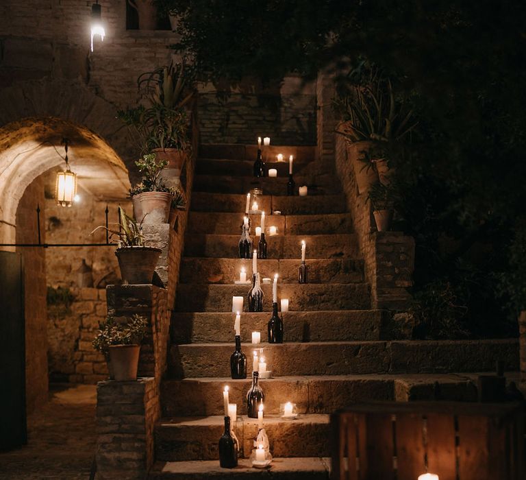 Candle lanterns decorating the stairs at rustic wedding venue