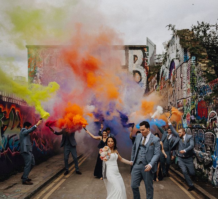 Bright and colourful wedding smoke flare for group photo 