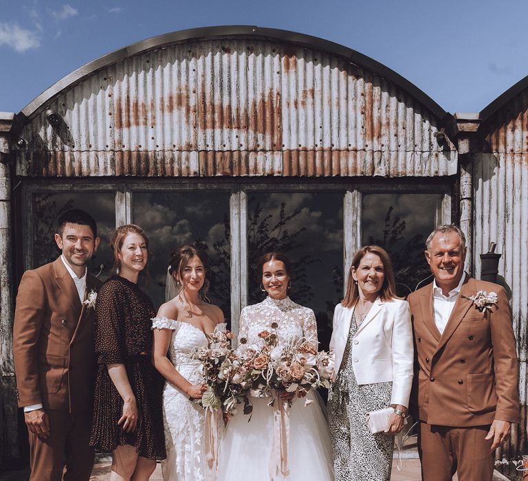 Two brides with family at the same sex wedding 