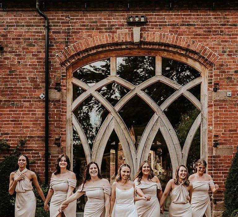 Bridal party wearing champagne coloured bridesmaid dresses for neutral wedding 