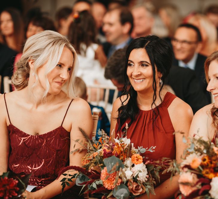 Bridesmaids in different rust coloured dresses at Millbridge Court wedding