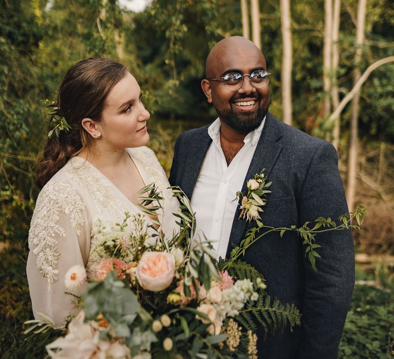 Bride looking at her groom by The Chamberlains Photography