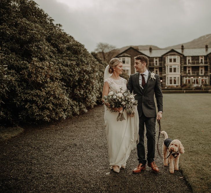 Happy couple on their wedding day with their dog at Inn on the Lake wedding