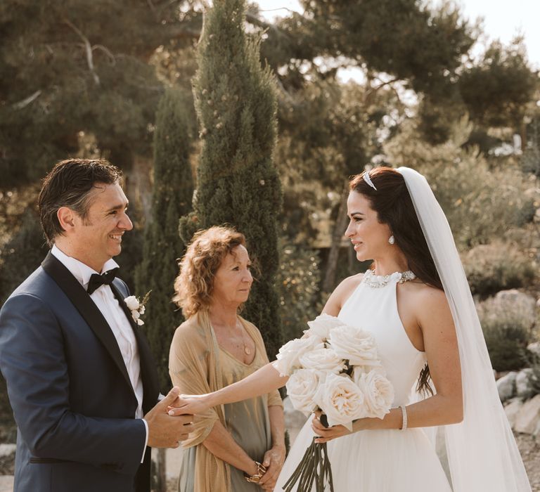 Bride and groom holding hands during the wedding ceremony 