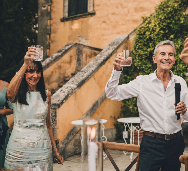 Wedding guests raising a toast at Tuscany Italy Wedding 