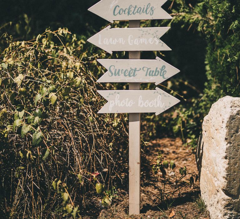 Wooden direction signs for outdoor wedding at Le Mas De La Rose