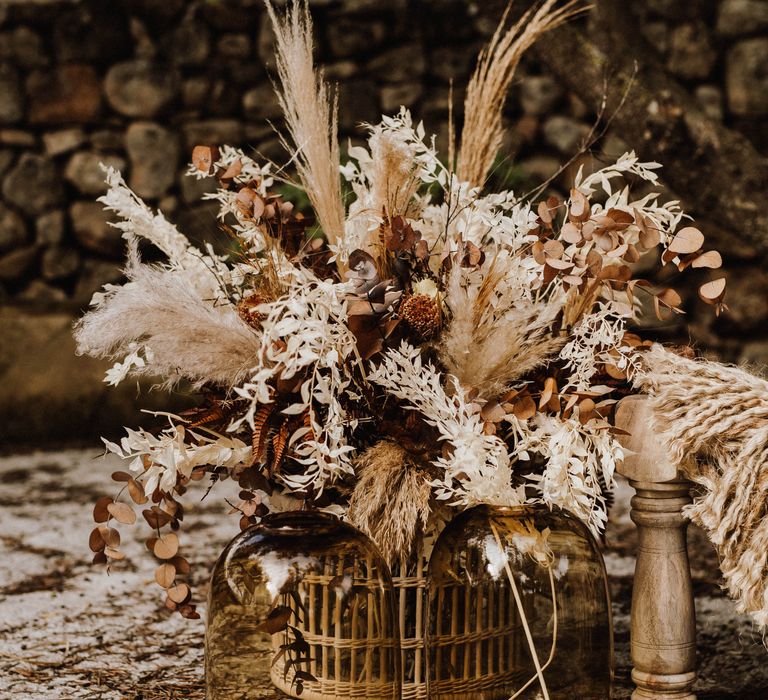 Large dried flowers bouquet in wicker vase