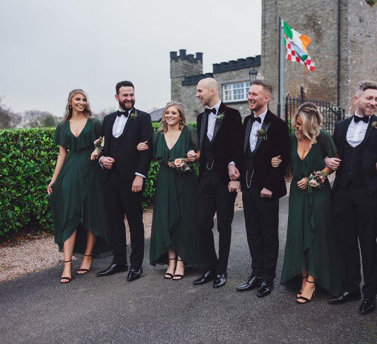 Wedding party portrait for Same sex wedding at Darver Castle with dark green groomsmaids dresses, tuxedos and burgundy velvet jackets 