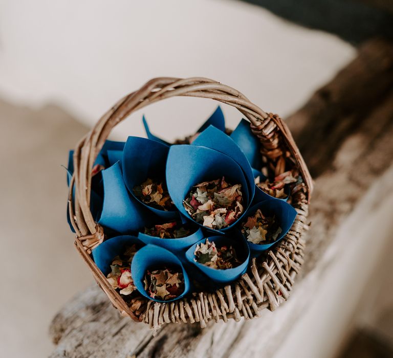 Navy blue confetti cones in a wicker basket 