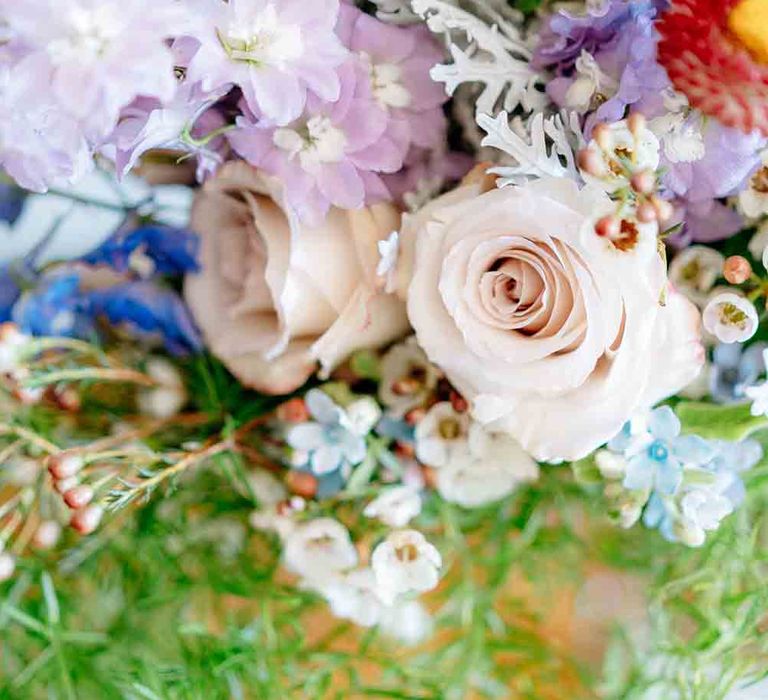 Beautiful wedding bouquet with roses and wildflowers