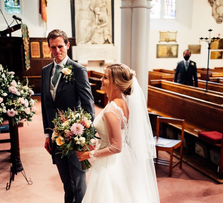 Bride & groom laugh during wedding ceremony