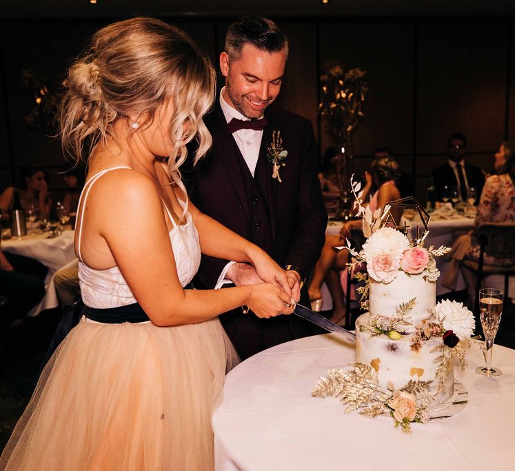 Bride and groom cut their wedding cake