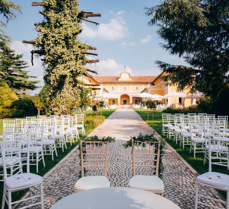 View from the bottom of the aisle of the wedding ceremony, facing the main villa at Tenuta Pegazzera