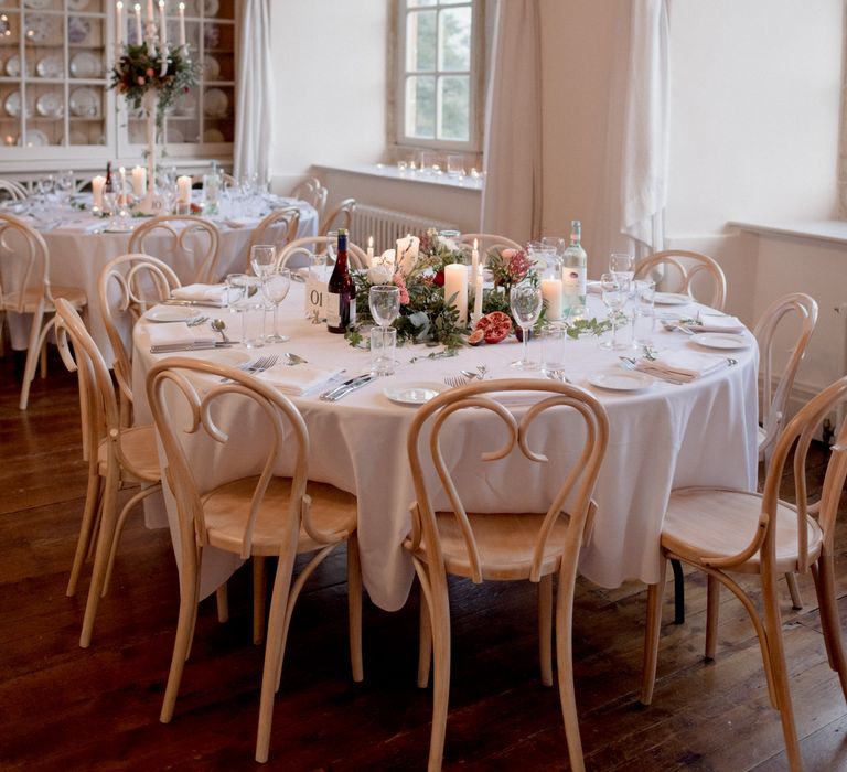 White and green wedding table decor with pomegranate with red and white wine 