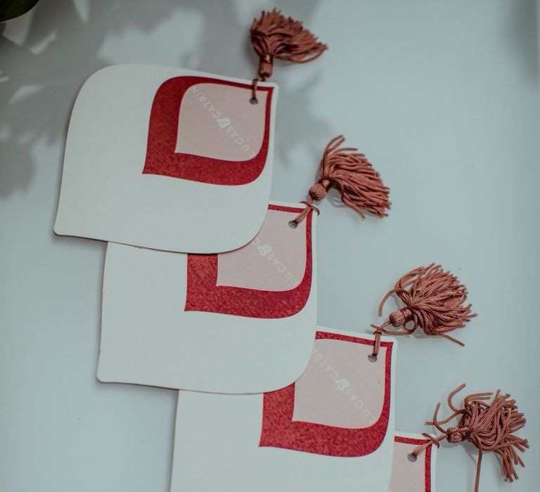 Pink, white and red wedding favours with tassel detail for 1960s themed micro wedding