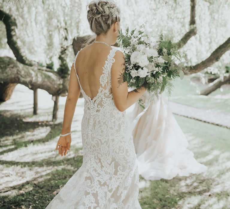 Two brides dance under the trees at Crab & Lobster fairytale wedding.