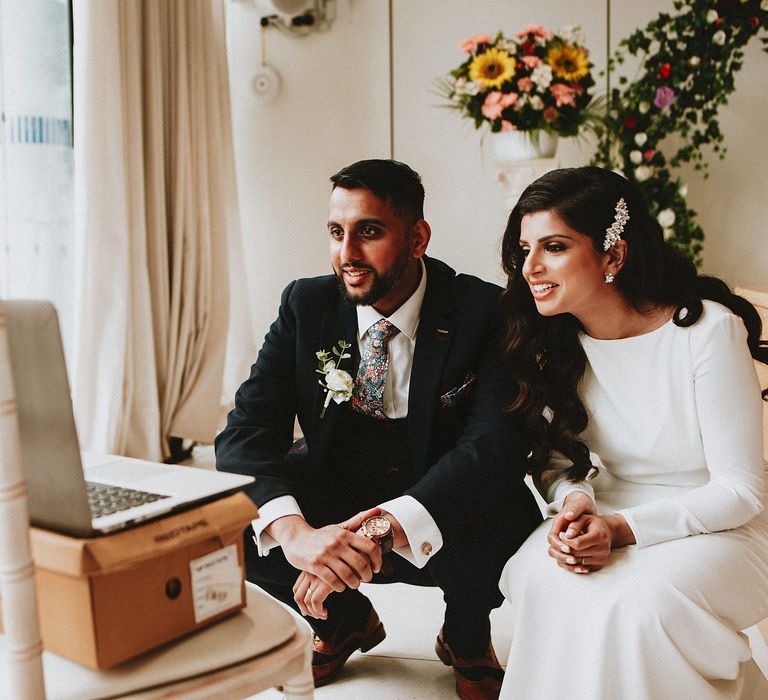 Bride and groom virtually speaking to wedding guests that couldn't make their intimate civil wedding ceremony 