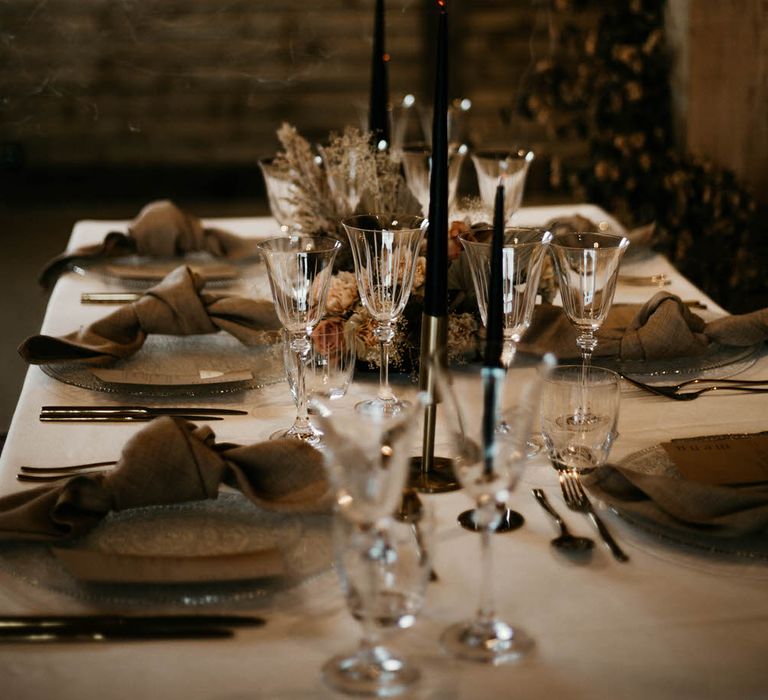 Neutral tablescape with black tapered candles for rustic luxe wedding ideas