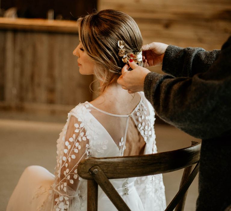 Bride having her hair styled with floral hair clip accessory from Garter & Veil